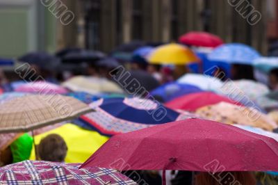 Crowd of people with umbrellas