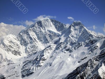Mountain under the blue sky and the clouds