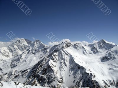 Mountain under the blue sky and the clouds