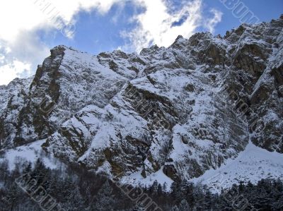 Mountain under the blue sky and the clouds