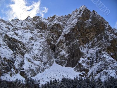 Mountain under the blue sky and the clouds