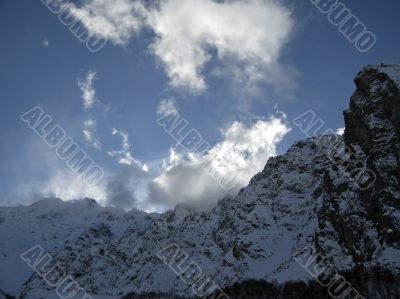 Mountain under the blue sky and the clouds
