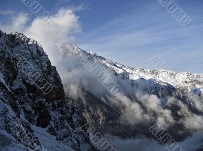 Mountain under the blue sky and the clouds