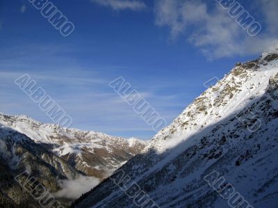 Mountain under the blue sky and the clouds