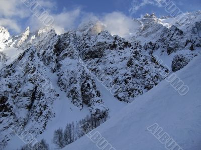 Mountain under the blue sky and the clouds