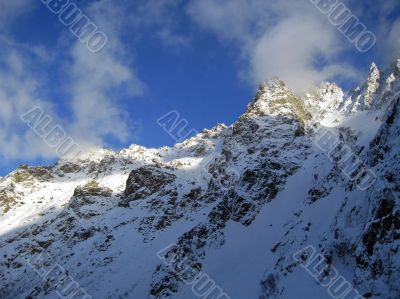 Mountain under the blue sky and the clouds