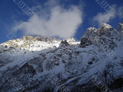 Mountain under the blue sky and the clouds