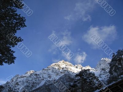 Mountain under the blue sky and the clouds