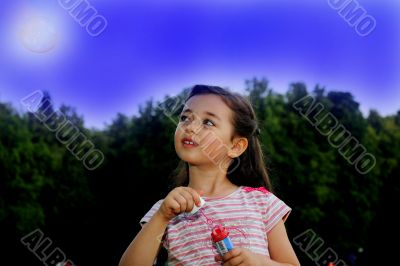 The little girl starts up soap bubbles