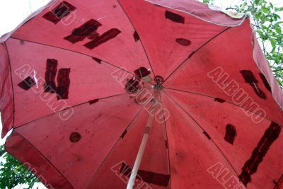 The umbrella with holes is stuck 