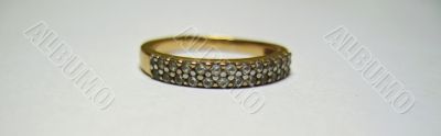 Golden ring with a white stone isolated