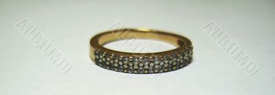 Golden ring with a white stones isolated