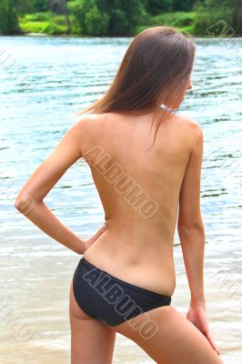 The young girl has a rest on a wood beach
