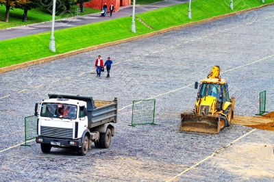 bulldozer and truck on the road