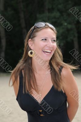 The young girl has a rest on a wood beach
