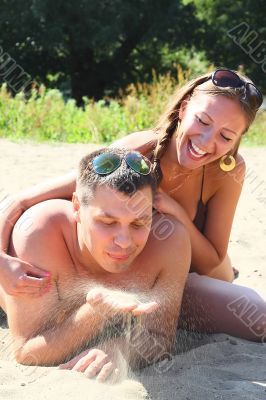Young men rest on a beach