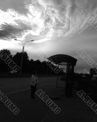 Silhouette of pavilion of a bus stop and cloud