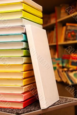 Book staying at stack of colorful books