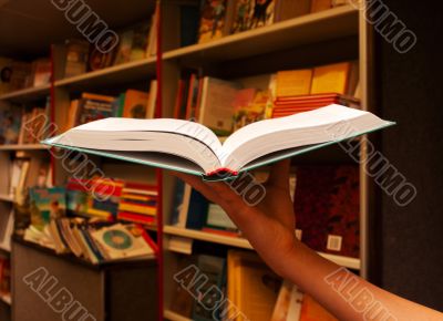 Hand holding open book