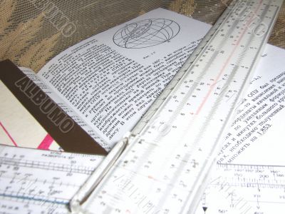 Still life with a book and two slide rules. 