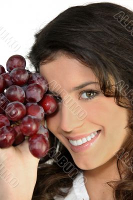 Woman with bunch of ripe grapes