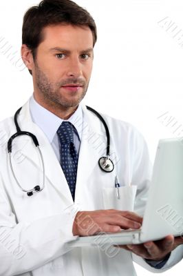 doctor holding laptop