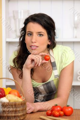 Woman holding small tomato