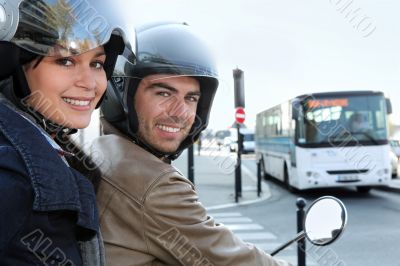 Couple on scooter in a crossroad