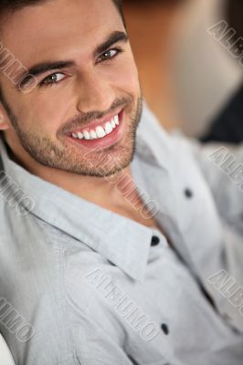 dark-haired man looking happy