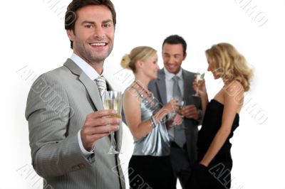 Man holding champagne glass with friends