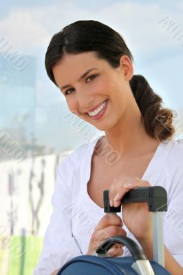 Smiling woman with a suitcase