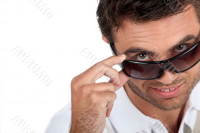 Man wearing sunglasses in studio