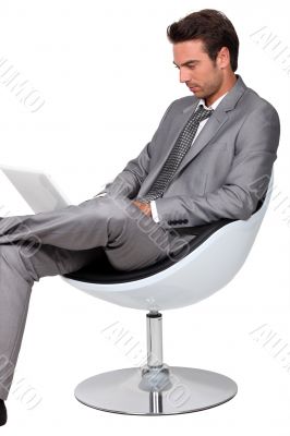 Smart young man using a laptop