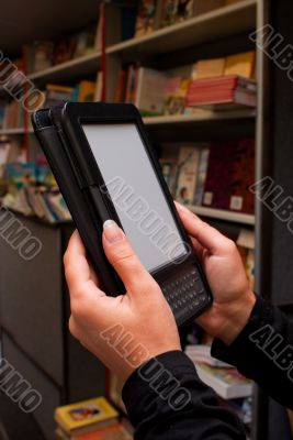 Woman`s hands holding electronic book reader