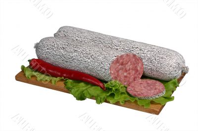 Salami on wooden board.