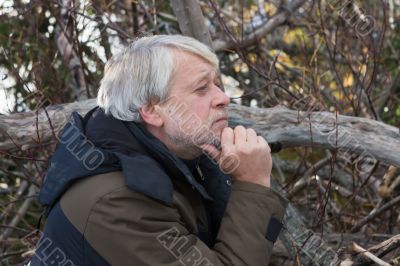 Middle-aged man in forest.