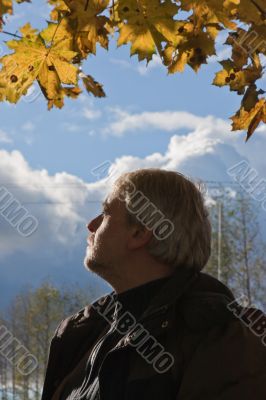 Portrait of middle-aged man in autumn day.