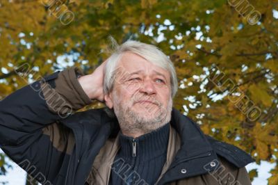 Portrait of middle-aged man in autumn day.