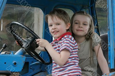 At the wheel.