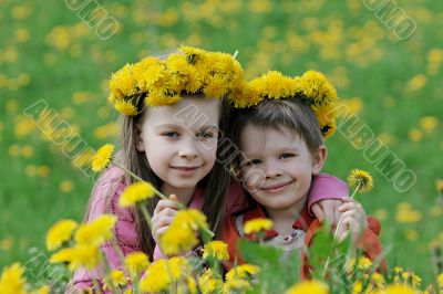 Brother and sister with dandelion garlands