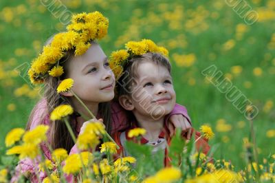 Brother and sister with dandelion garlands