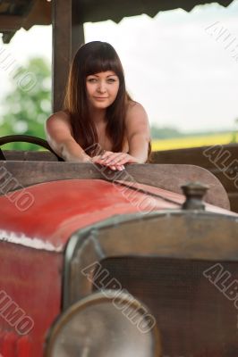 Young woman with old car.
