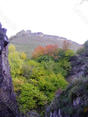 Golden autumn, blue sky and caucasus mountains