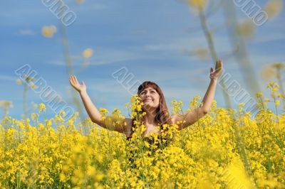 Happy girl in flower meadow.
