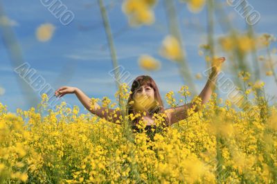Happy girl in flower meadow.