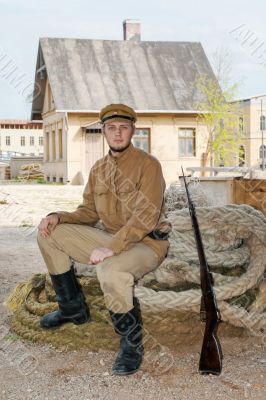 Retro style picture with soldier sitting on rope
