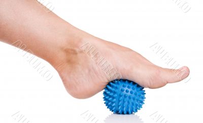 Woman`s foot with massage ball