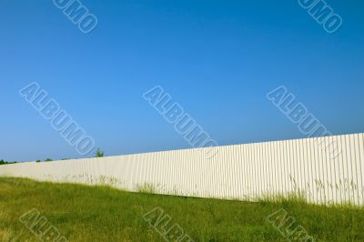 Long white metal fence