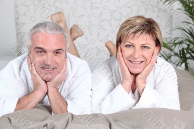 senior couple lying in bed