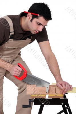Man cutting a piece of wood